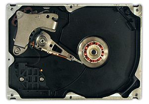 A hard disk drive with the platters and motor ...